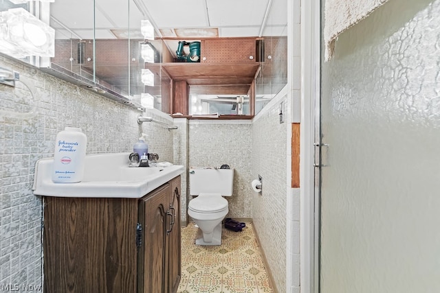 bathroom with tile flooring, vanity, and toilet