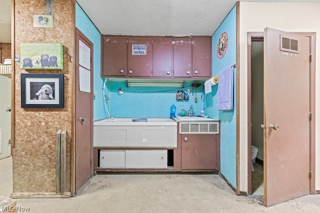 kitchen with sink and a textured ceiling