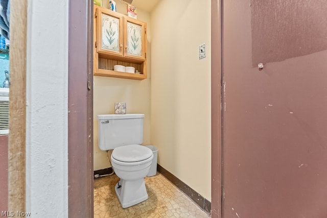 bathroom featuring tile floors and toilet