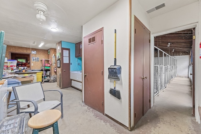 hall with a textured ceiling