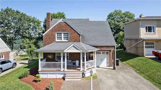 view of front of property featuring covered porch, a front yard, and a garage