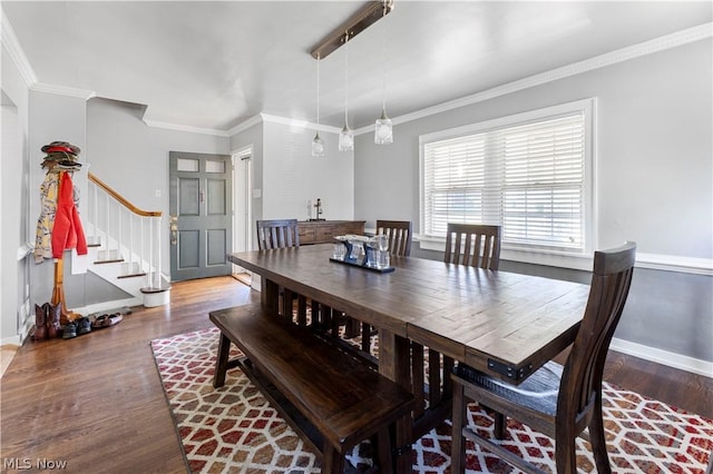 dining space featuring dark hardwood / wood-style flooring and crown molding