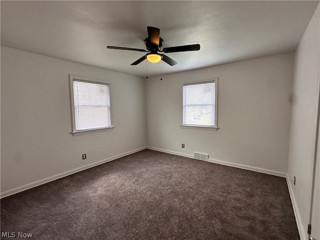 carpeted empty room with ceiling fan and a healthy amount of sunlight