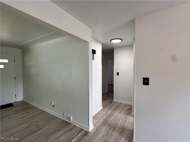 corridor with wood-type flooring