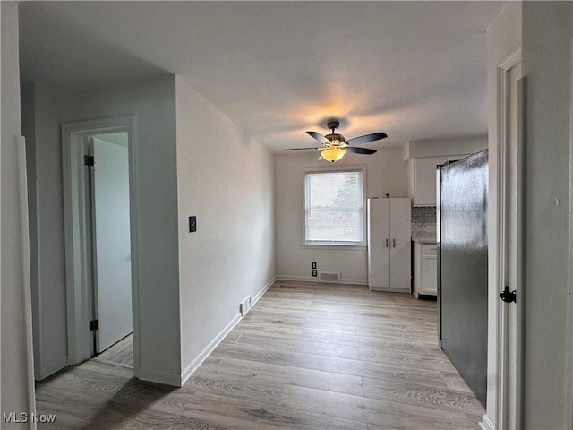 corridor featuring light wood-type flooring