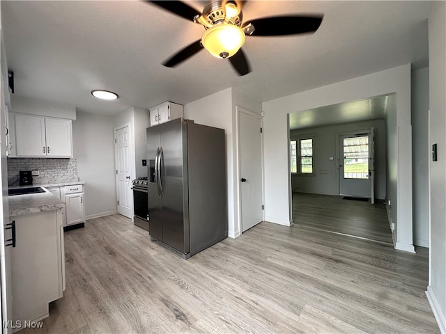 kitchen with white cabinetry, ceiling fan, decorative backsplash, light hardwood / wood-style floors, and appliances with stainless steel finishes