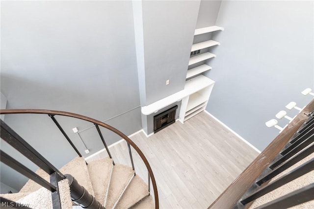 staircase with hardwood / wood-style flooring