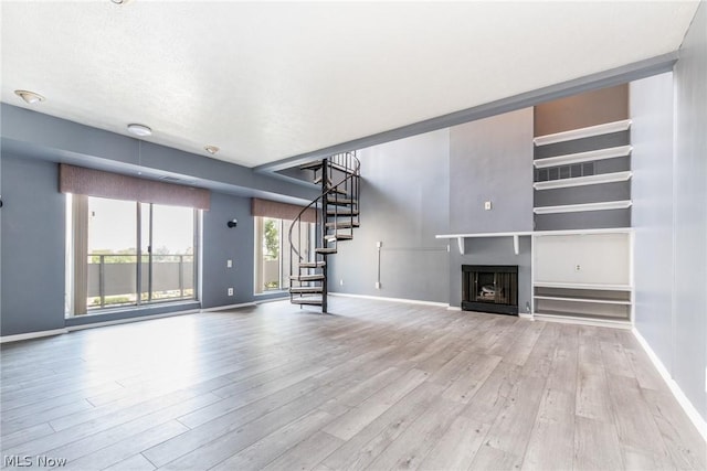 unfurnished living room featuring light wood-type flooring