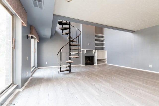 unfurnished living room with light hardwood / wood-style flooring