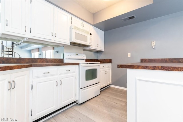 kitchen featuring white cabinets, white appliances, and light hardwood / wood-style flooring