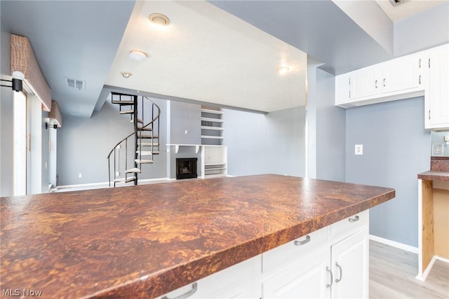 kitchen with white cabinets and light wood-type flooring