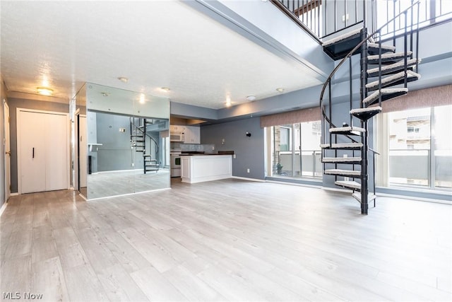 unfurnished living room featuring light wood-type flooring