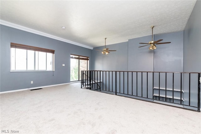 unfurnished room with ceiling fan, crown molding, carpet floors, and lofted ceiling