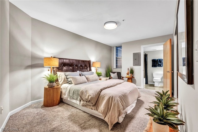 carpeted bedroom featuring electric panel and ensuite bath