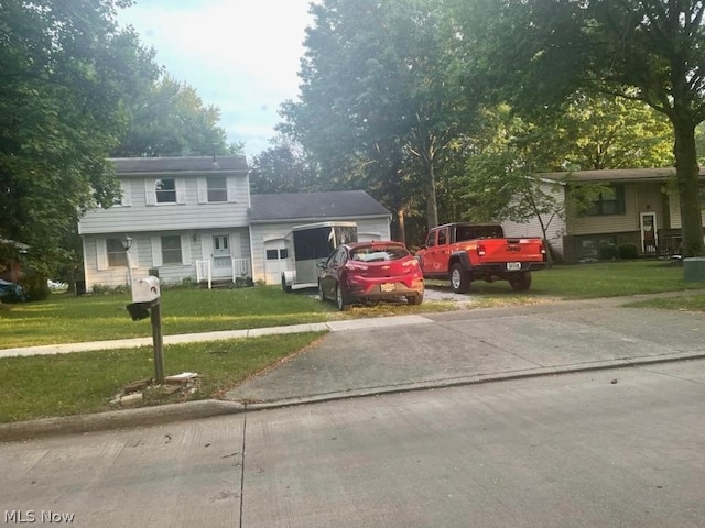 view of front of house with a garage and a front lawn