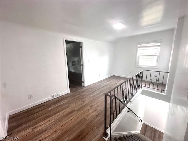 spare room with dark hardwood / wood-style floors