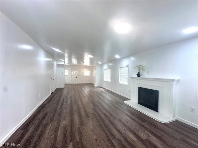 unfurnished living room featuring dark wood-type flooring