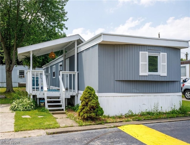 view of home's exterior featuring a wooden deck