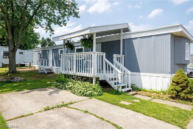 rear view of property featuring a wooden deck