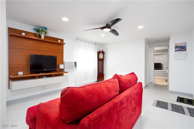 living room featuring baseboards, a ceiling fan, and recessed lighting