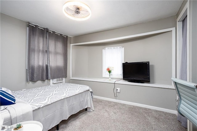 carpeted bedroom with baseboards