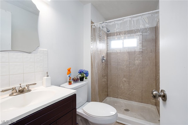 bathroom featuring tasteful backsplash, vanity, a shower with shower curtain, and toilet