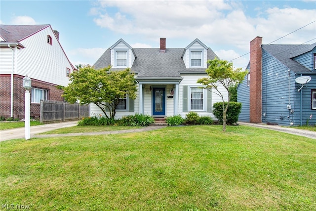 cape cod home featuring a front lawn