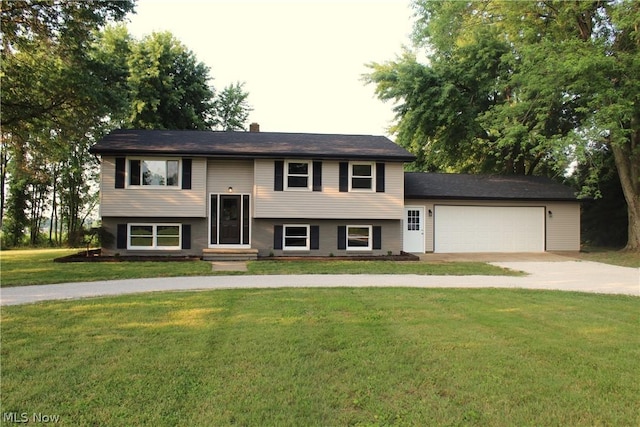 bi-level home featuring a garage and a front yard