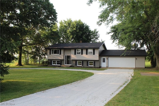 bi-level home with a garage and a front yard