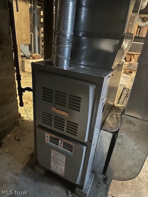 utility room featuring heating unit