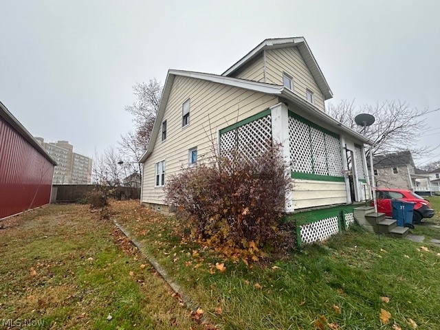 view of side of home featuring a lawn