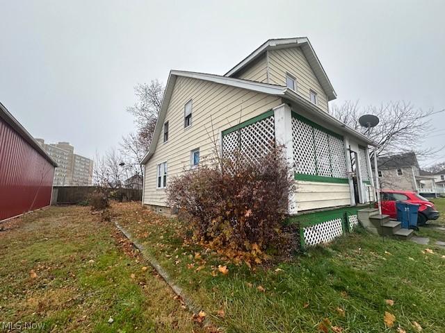 view of side of home with a lawn