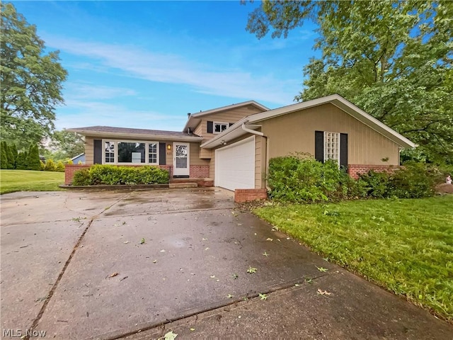 split level home with a garage and a front yard