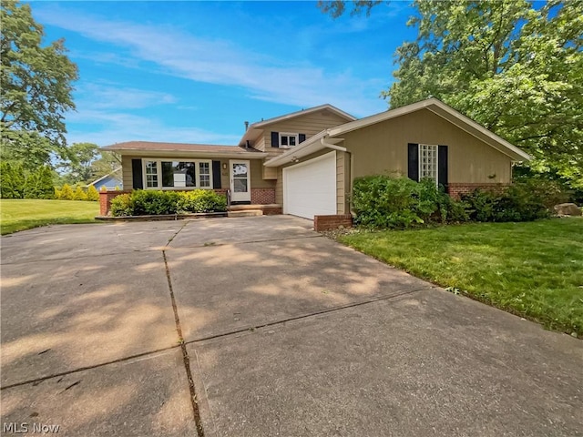 view of front of home with a garage and a front lawn