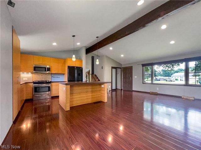 kitchen with a kitchen island, dark hardwood / wood-style flooring, appliances with stainless steel finishes, and tasteful backsplash