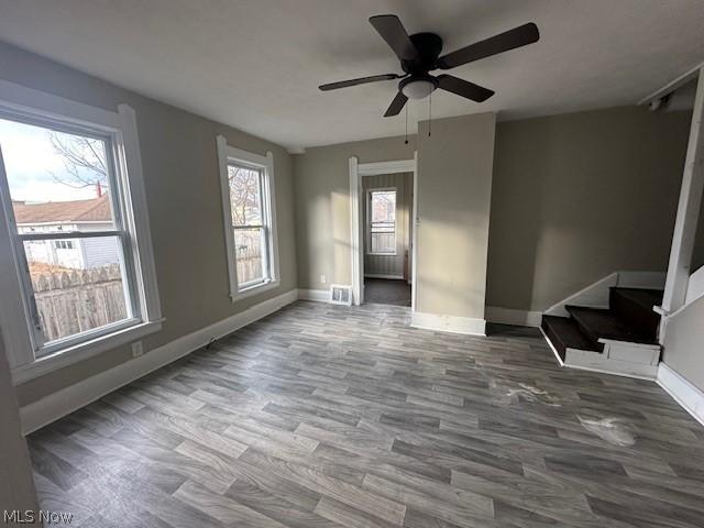 empty room featuring wood-type flooring and ceiling fan