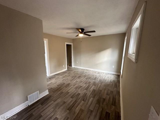 unfurnished room featuring dark hardwood / wood-style flooring and ceiling fan