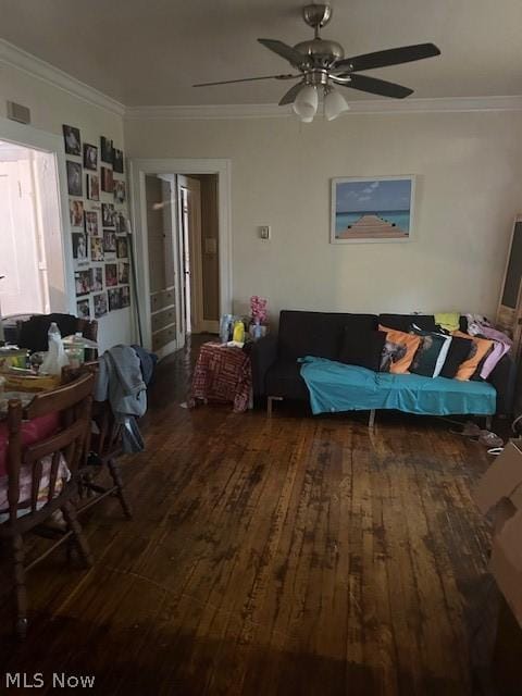 living room with dark hardwood / wood-style flooring, ceiling fan, and ornamental molding