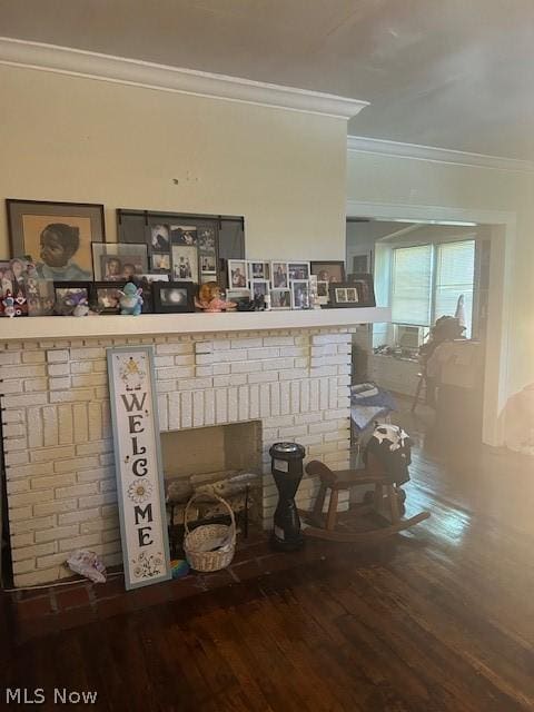 details featuring hardwood / wood-style flooring, crown molding, and a brick fireplace