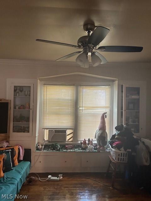 interior space featuring ceiling fan, cooling unit, wood-type flooring, and ornamental molding