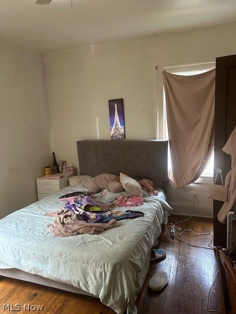 bedroom with ceiling fan and hardwood / wood-style floors