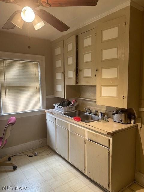 kitchen featuring ceiling fan and sink