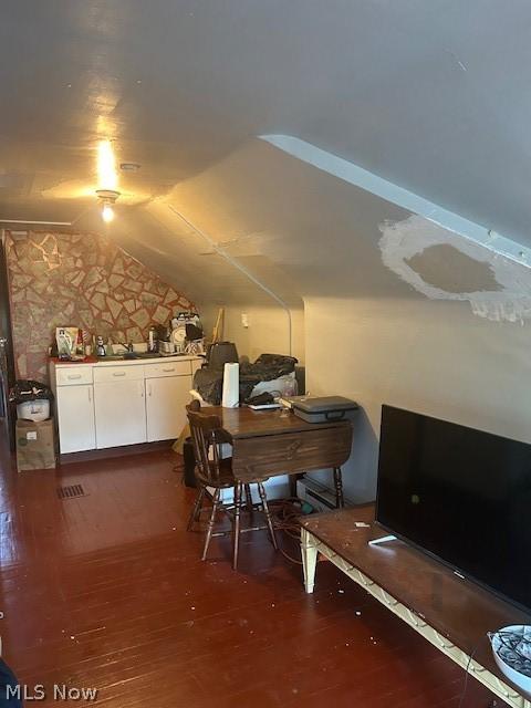 bonus room featuring dark hardwood / wood-style flooring and vaulted ceiling