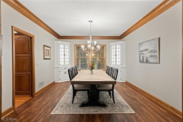 dining space featuring a wealth of natural light, crown molding, dark hardwood / wood-style flooring, and a chandelier