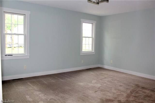 unfurnished room featuring carpet