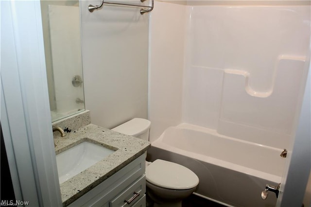 full bathroom featuring bathtub / shower combination, vanity, and toilet