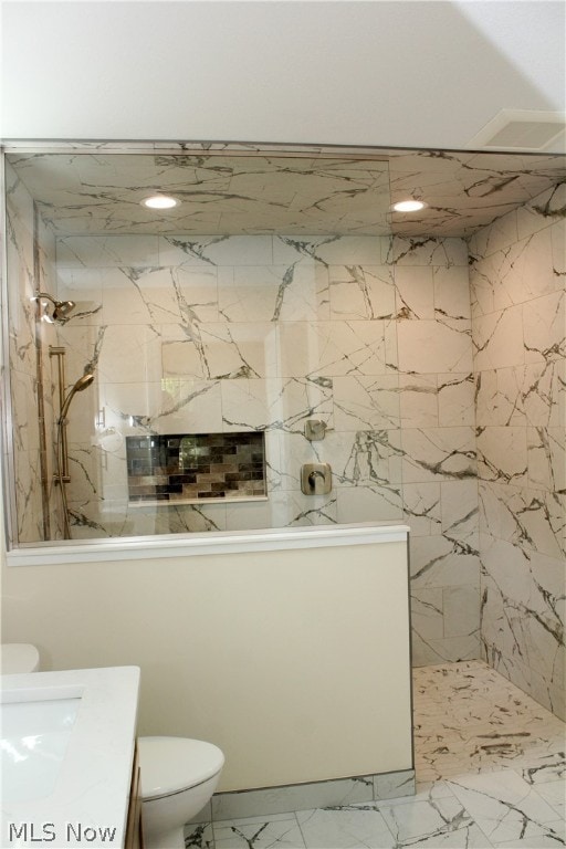 bathroom with tile flooring, vanity, and toilet