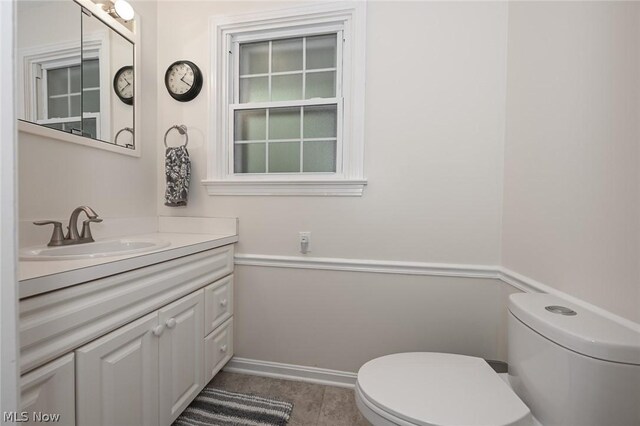 bathroom featuring vanity, toilet, and tile patterned flooring