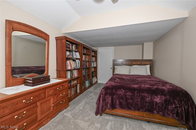 carpeted bedroom featuring lofted ceiling