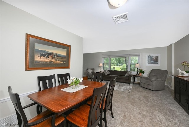 dining area featuring light colored carpet and visible vents